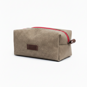 Beige toiletry bag with red zipper on a white background