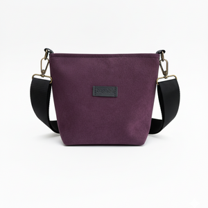 Purple handbag with black strap on a white background