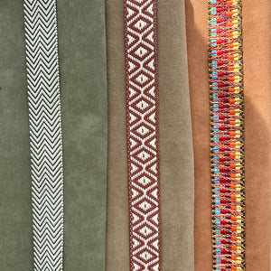Collection of fabric swatches with different patterns and colors on a neutral background
