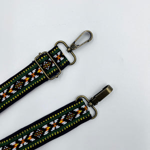 Adjustable Folk Shoulder Strap with a colorful geometric pattern and metal buckle, laid out on a white background.