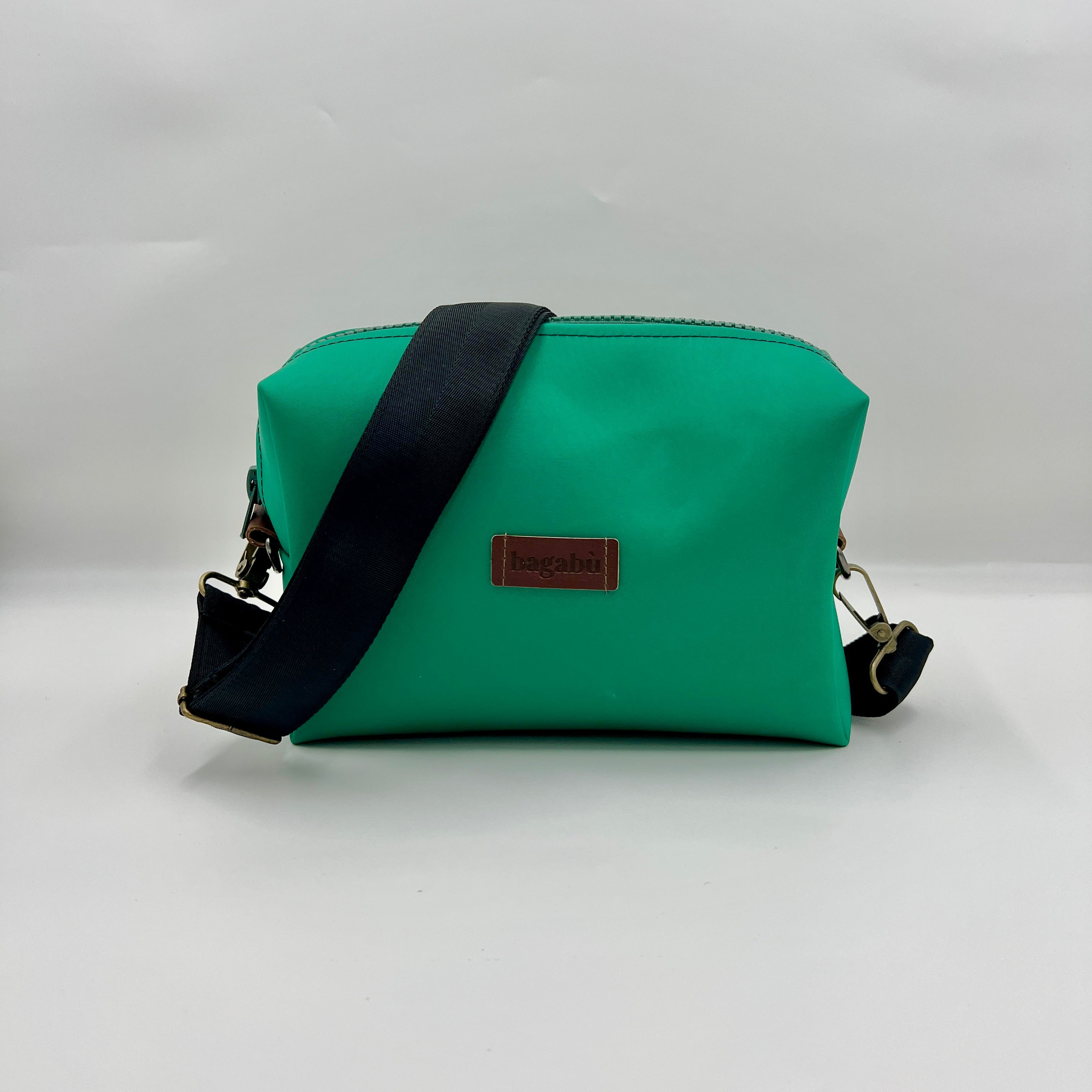 A green rambler bag with a blue strap