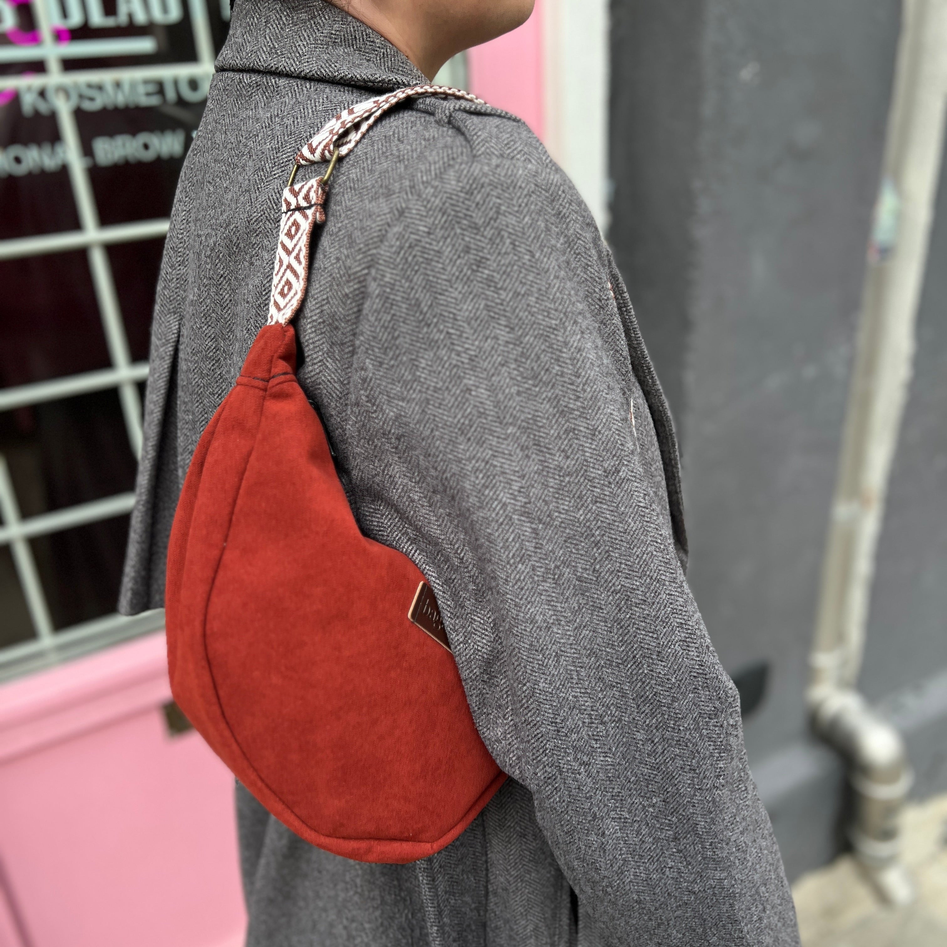 Person wearing a brown backpack in an urban setting