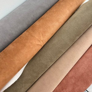Collection of alcantara strips in various brown and gray colors.