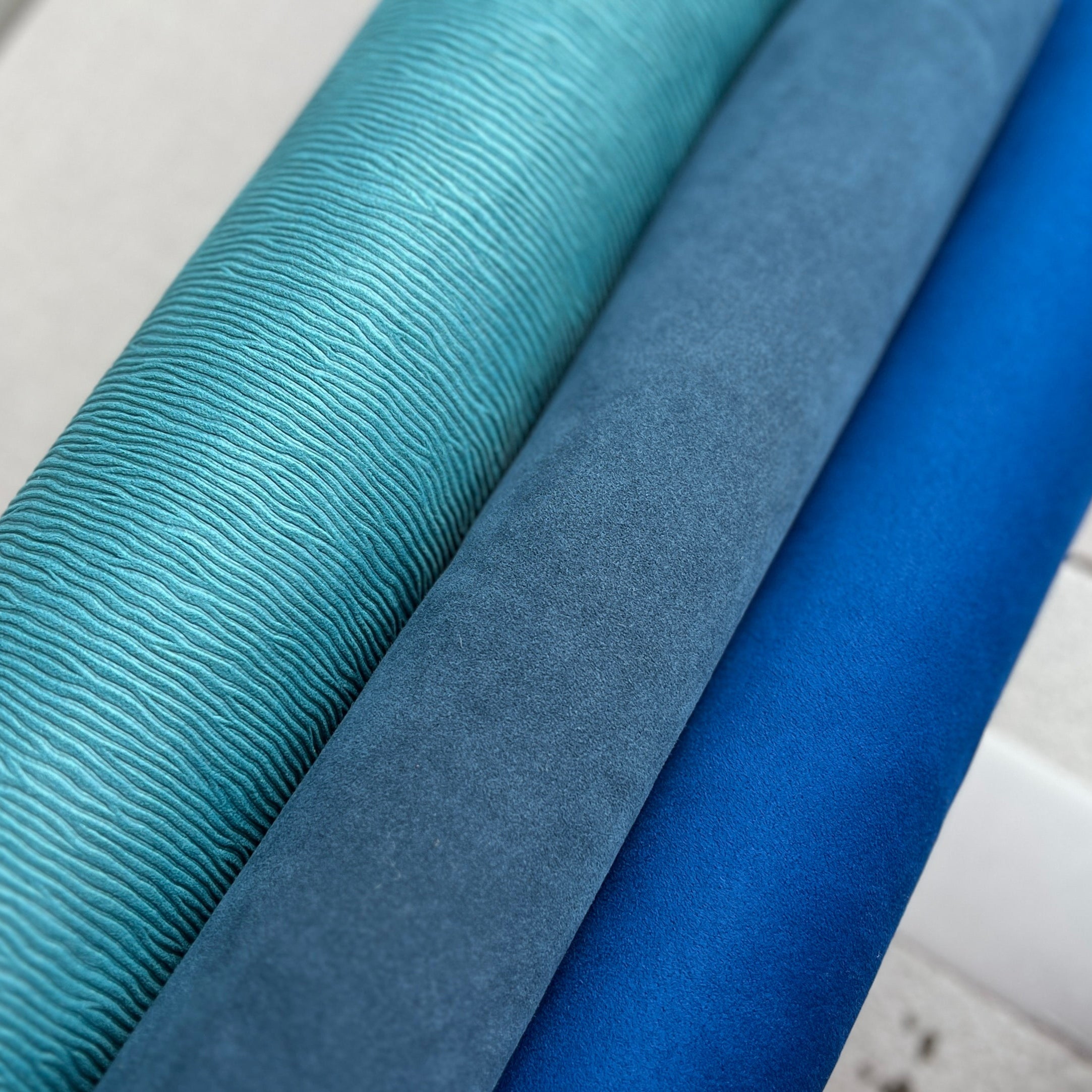 Close-up of blue fabric swatches on a white background