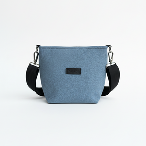 Blue crossbody bag with a black strap on a white background