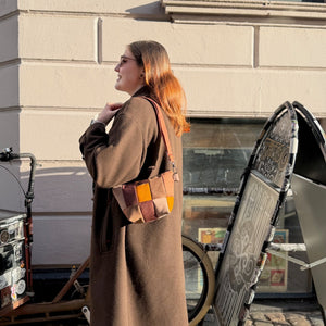 brown and orange patch bag