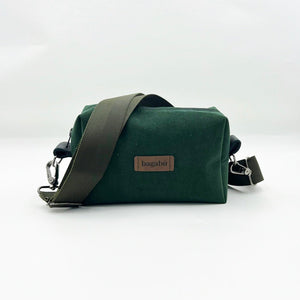 A green shoulder bag with a black shoulder strap and a brand name 'bagabü' visible on the front.