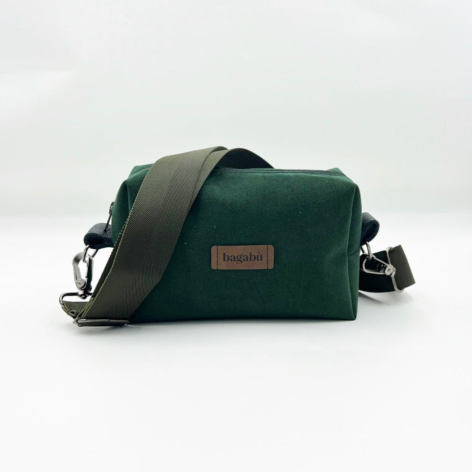 A green shoulder bag with a black shoulder strap and a brand name 'bagabü' visible on the front.
