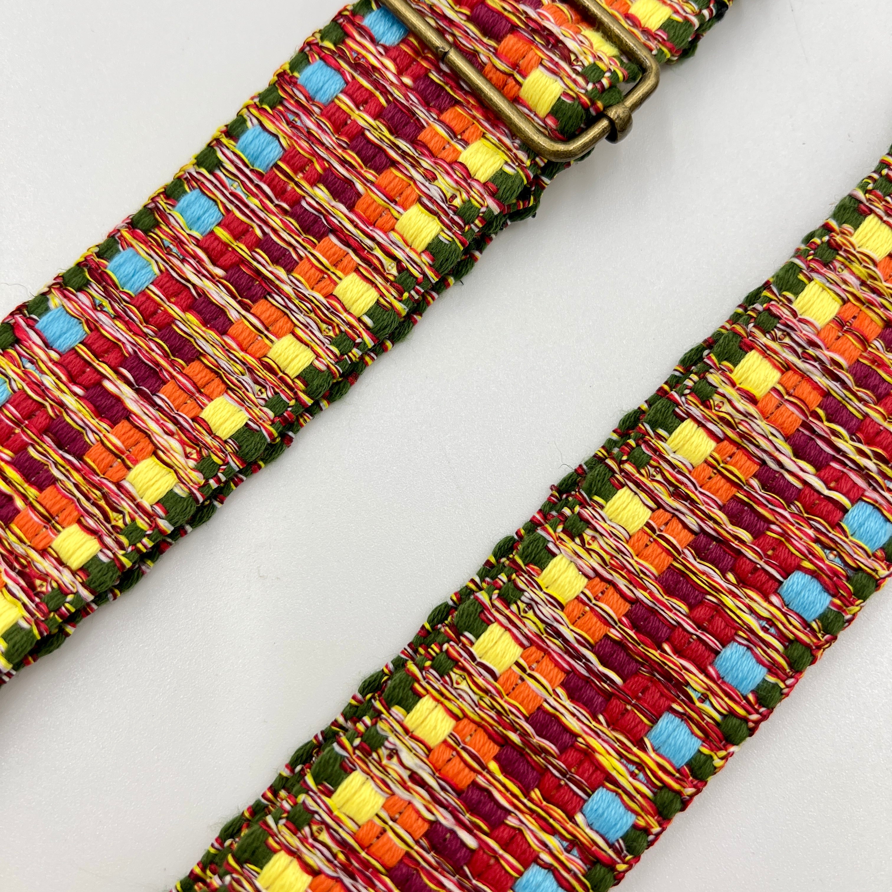 Colorful woven belt with a pattern on a light gray background