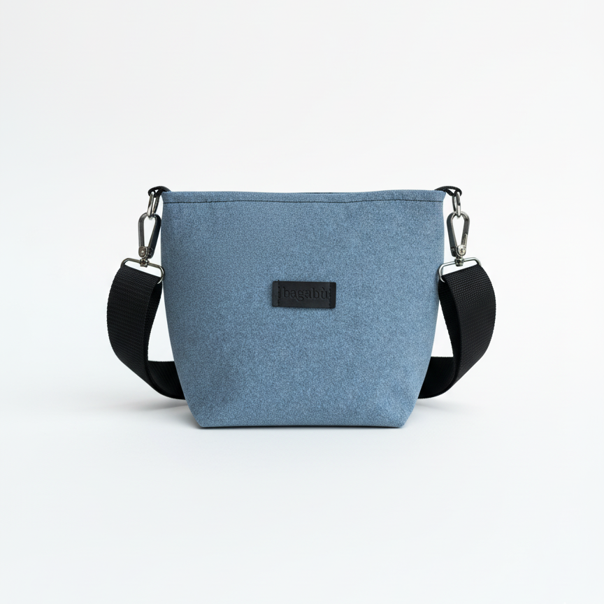 Blue crossbody bag with a black strap on a white background