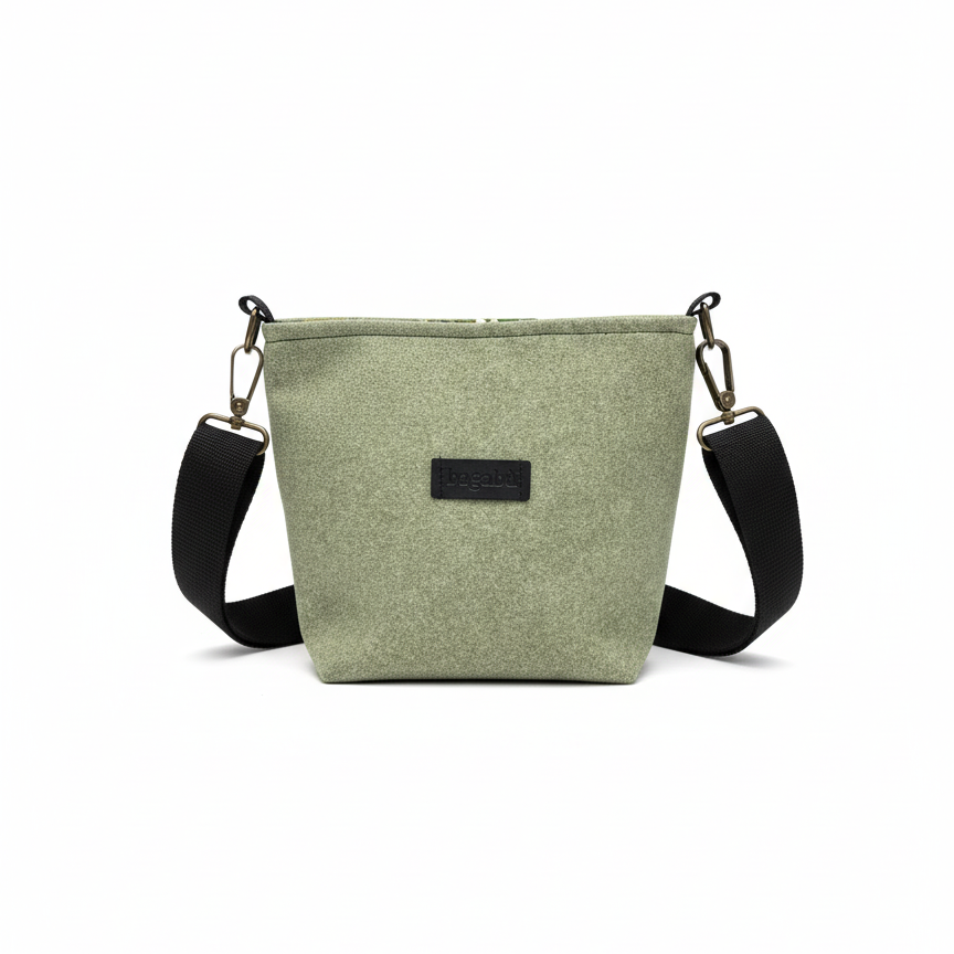 Green crossbody bag with black strap on a white background