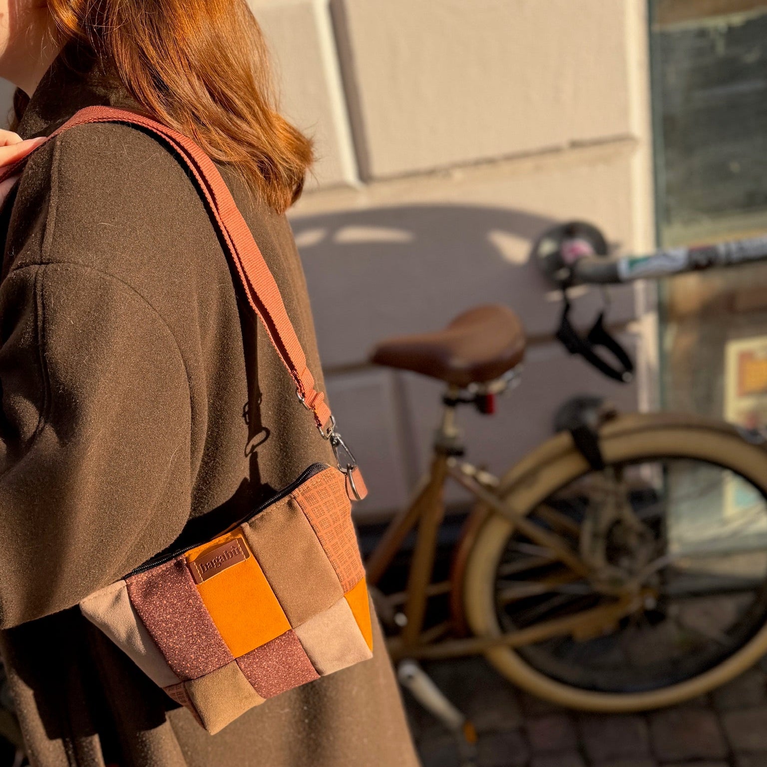 brown and orange patch bag