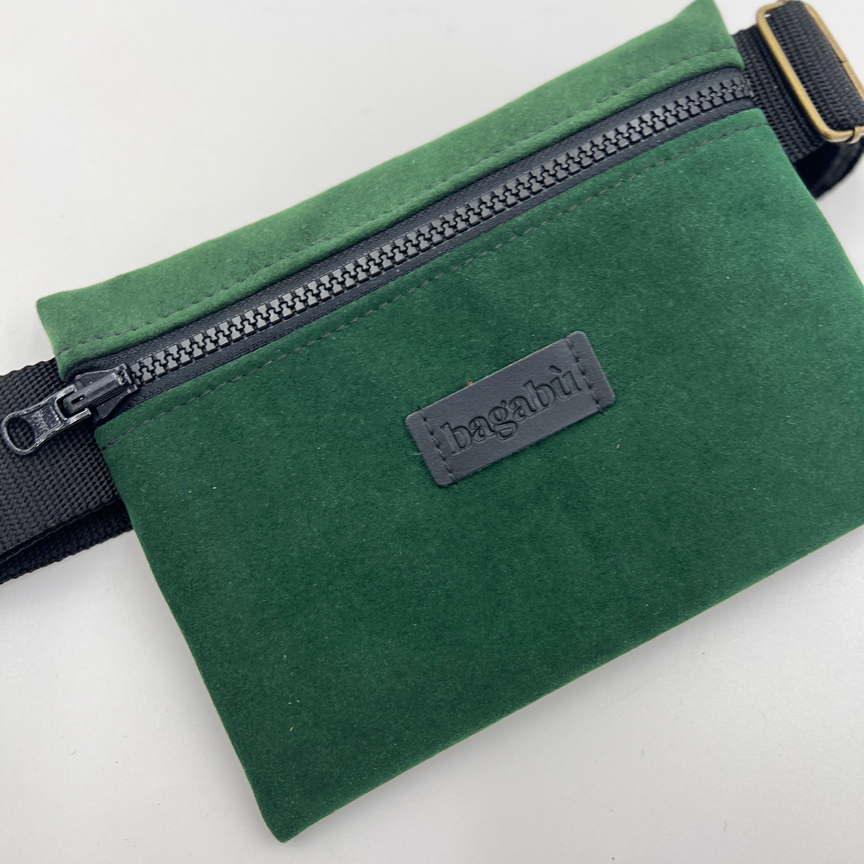 Green waist bag with a visible brand logo on a white background