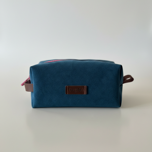 dark blue toiletry bag with pink zipper