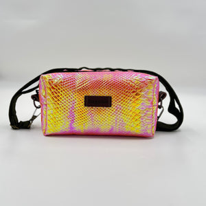 Pink and yellow patterned crossbody bag on a light gray background
