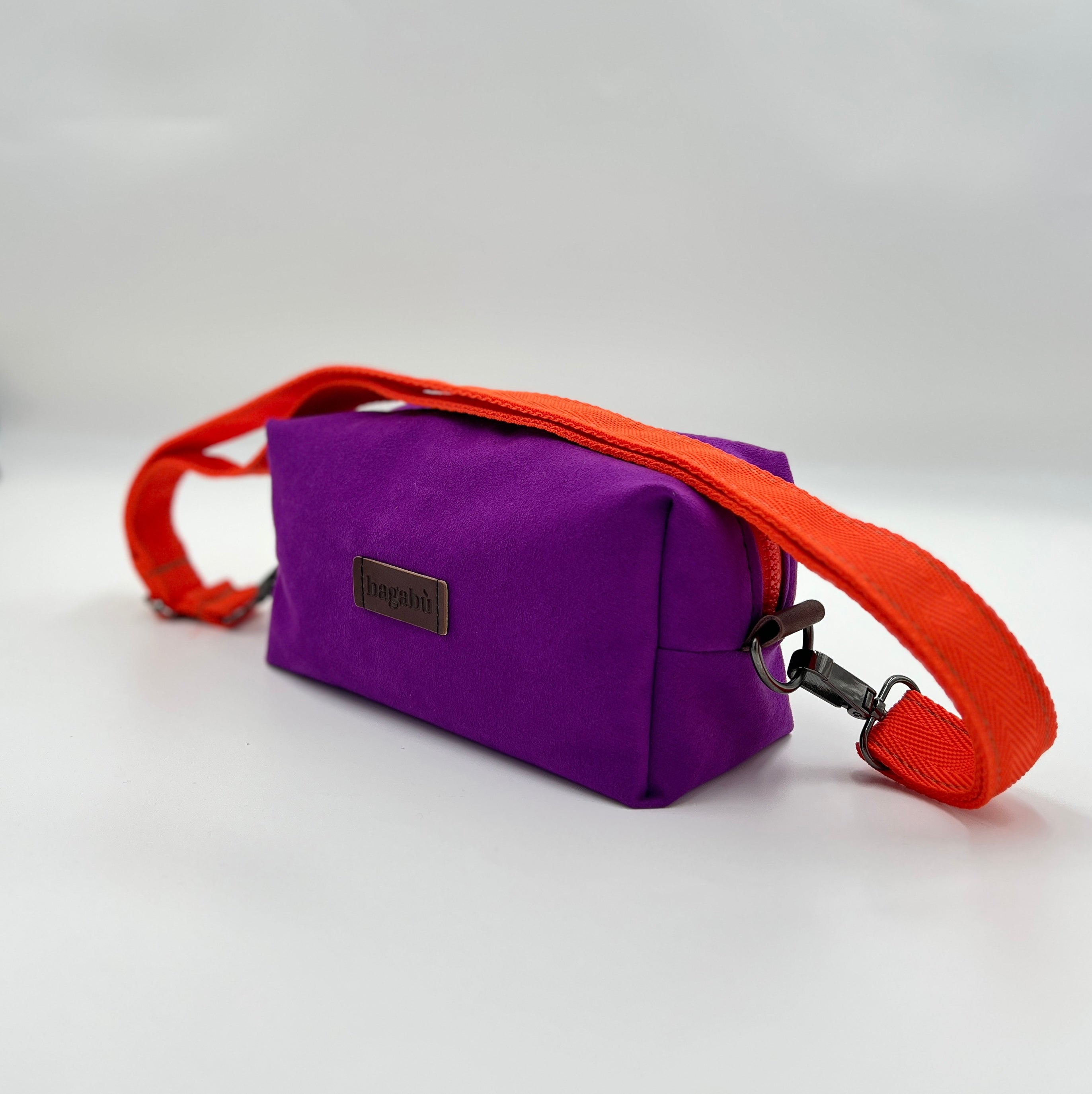 Purple bag with an orange strap on a white background