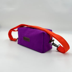Purple bag with an orange strap on a white background