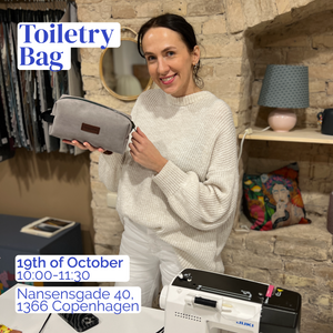 Woman holding a toiletry bag with event details displayed